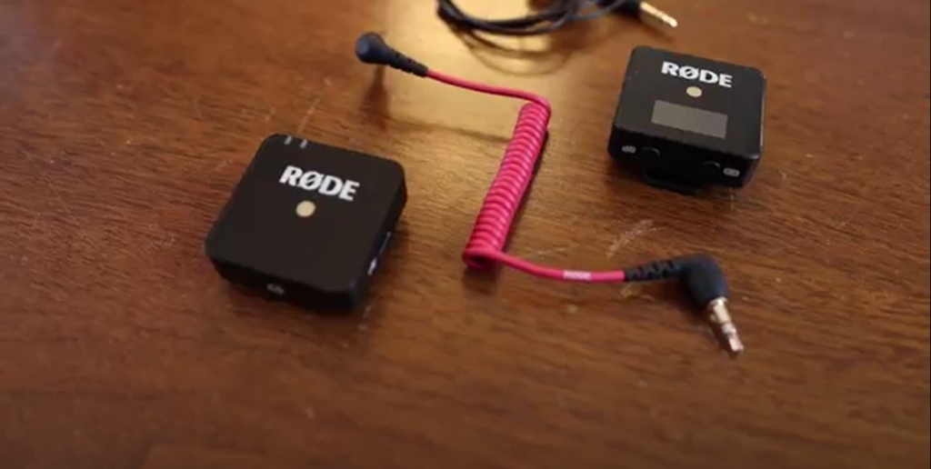 On the table, there is the Rode Wireless Go transmitter and receiver. 